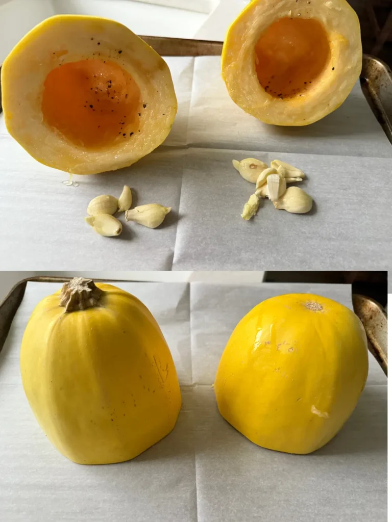 Two halves of a spaghetti squash with garlic cloves underneath on a sheet pan lined with parchment paper.