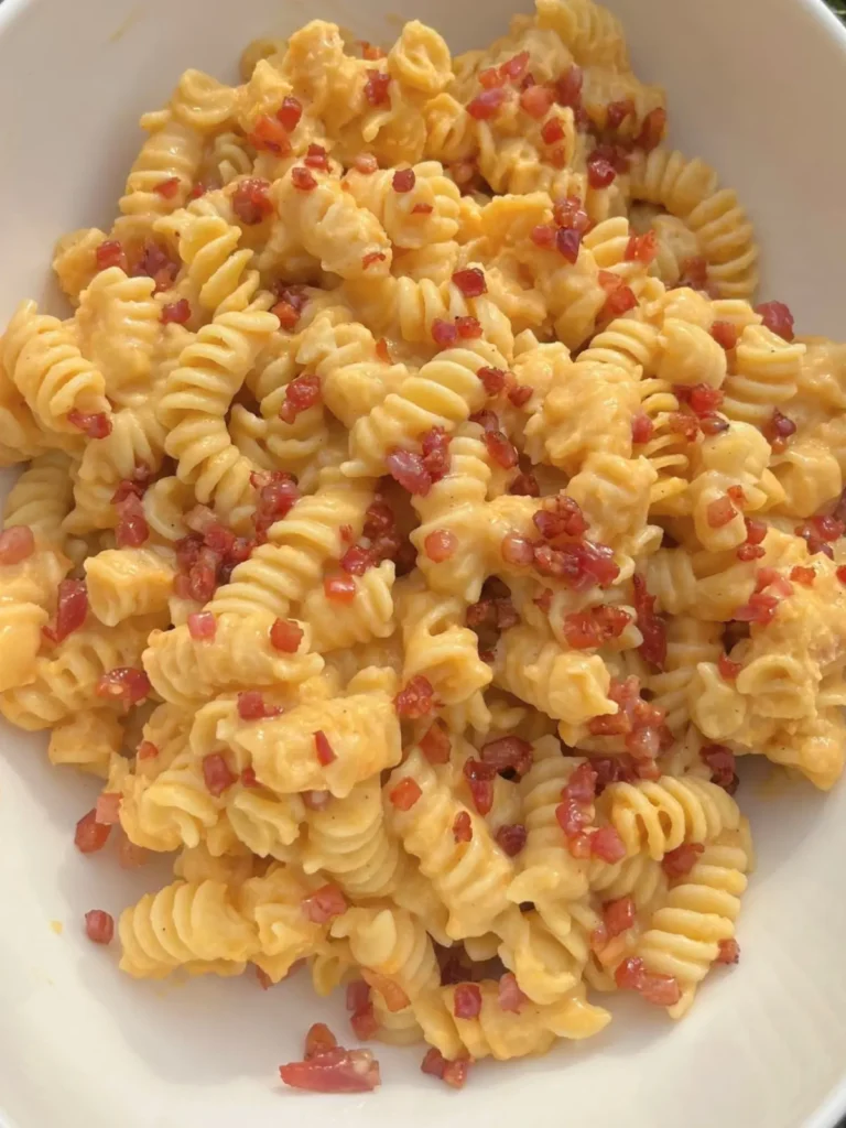 A close-up of a bowl of butternut squash and cottage cheese pasta sauce.