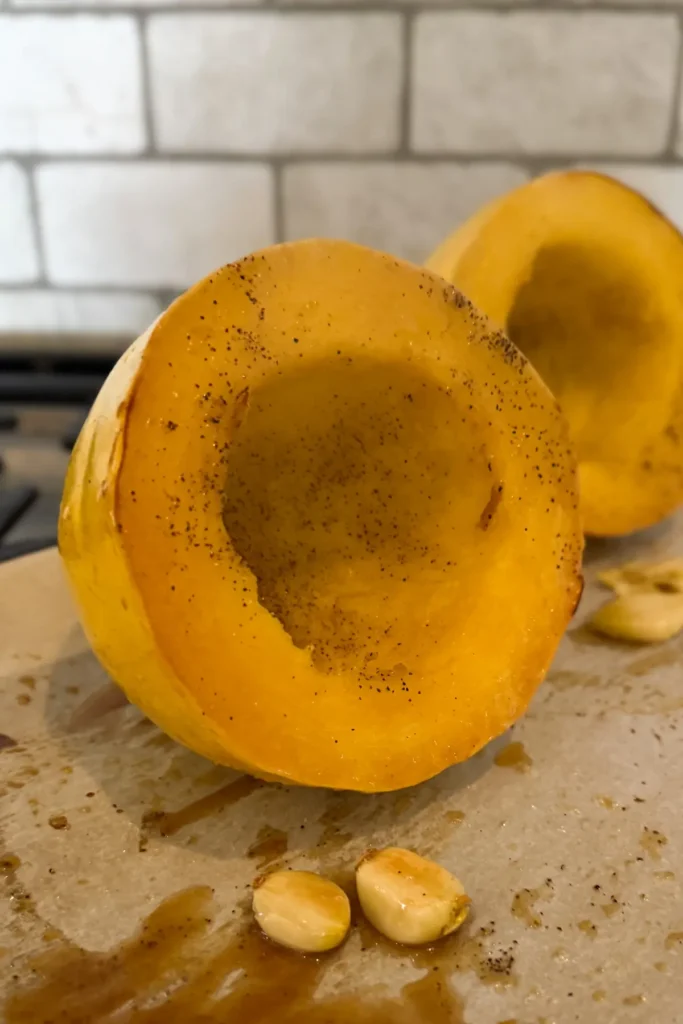 The spaghetti squash halves resting after baking on a baking sheet. 