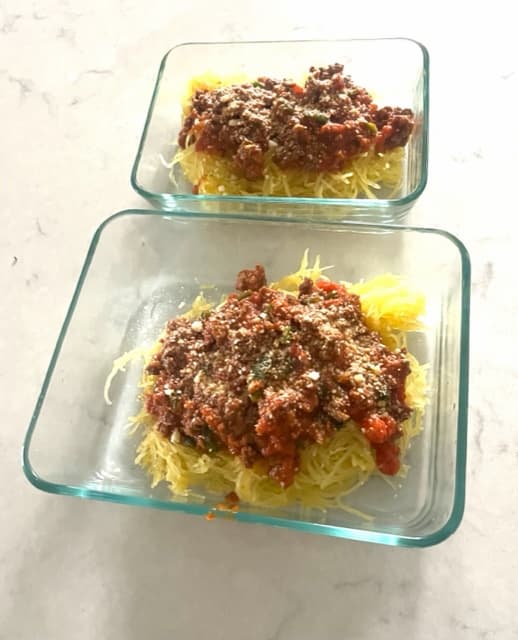Spaghetti squash with meat sauce in two separate storage containers.