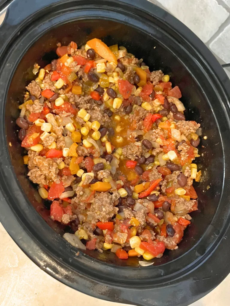 A birds-eye view of the Mexican chili in a crockpot on the counter.