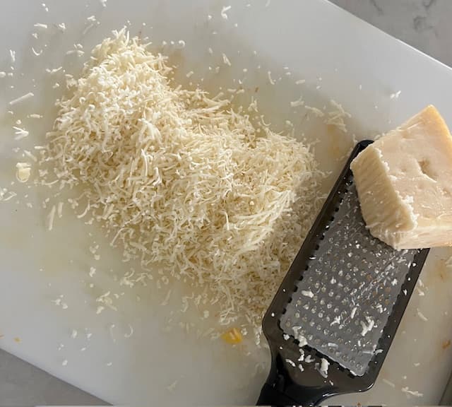 Grating the Parmesan Cheese for Butternut Squash Quinoa bowl.