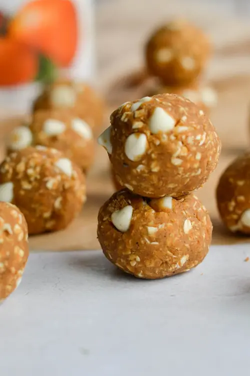 High protein oatmeal bites stacked on top of each other on a countertop.