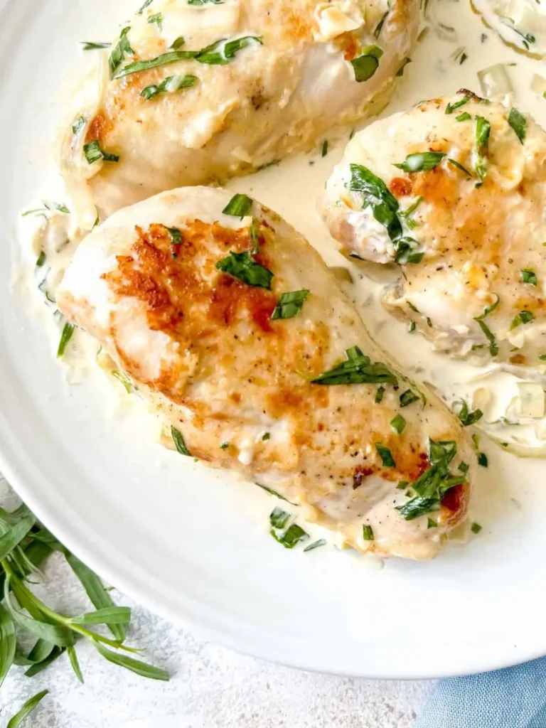 Creamy tarragon chicken on a large platter on a table.