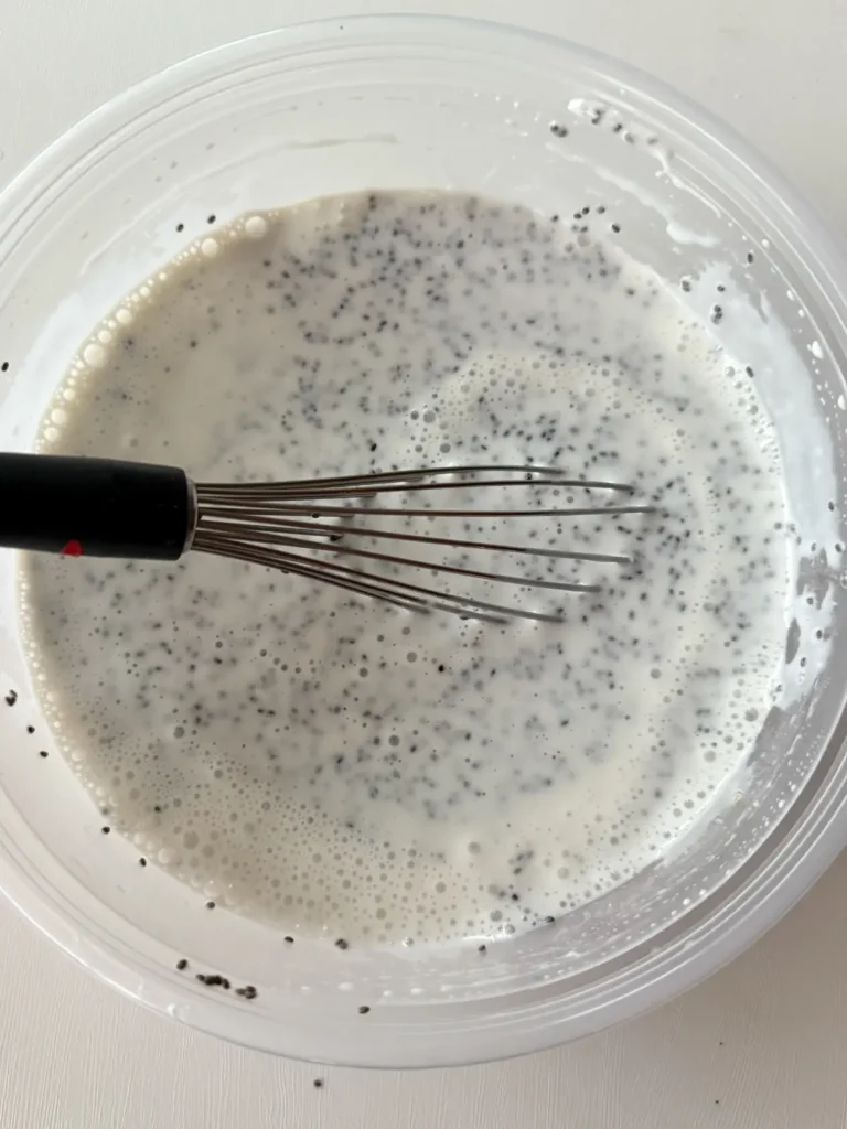 Whisking the chia breakfast bowl base in a bowl.