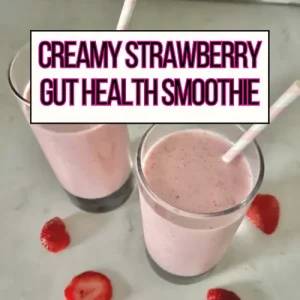 Two creamy strawberry gut health smoothies in large glasses with pink straws - main header image.