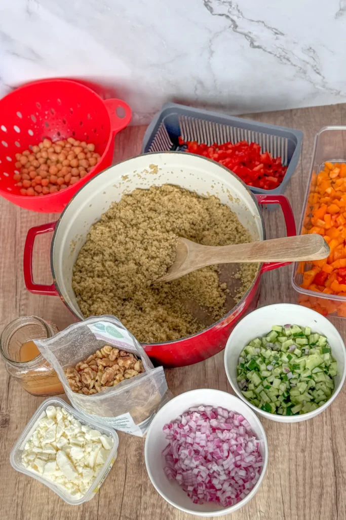 All of the components for the grain bowl minus the chicken in separate bowls on a counter.