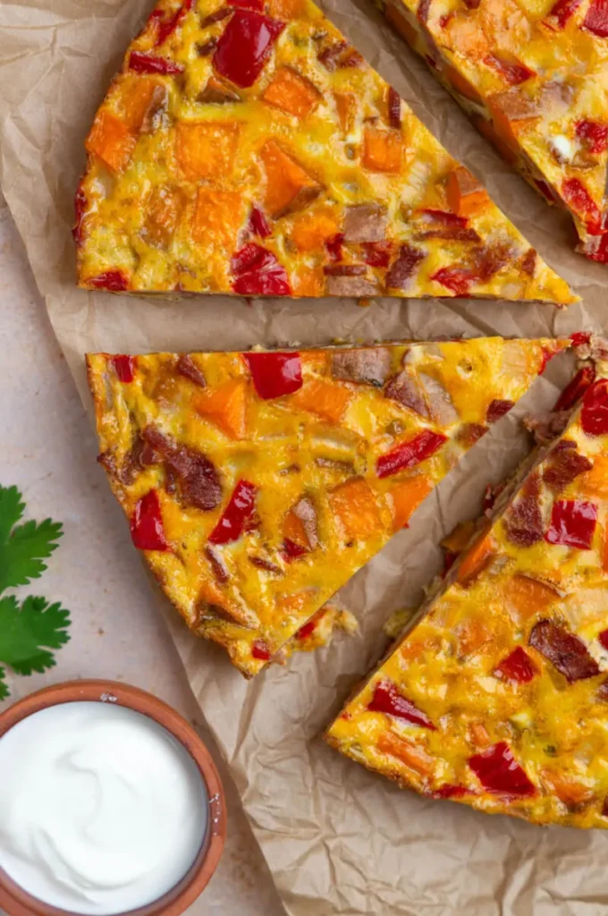 Gluten-free Southwest frittata slices on parchment paper on a table.