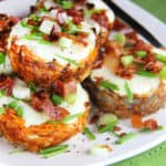 Sweet potato hash and egg breakfast cups stacked together on a white plate.