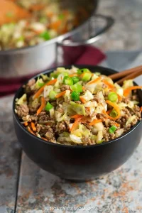 Egg roll in a bowl with chopsticks for a lazy Sunday dinner idea.