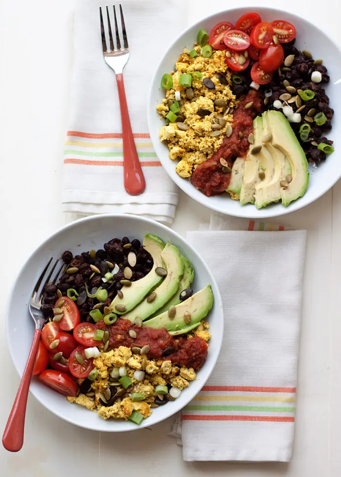 Two high protein vegan breakfast bowls on a towel on a table.