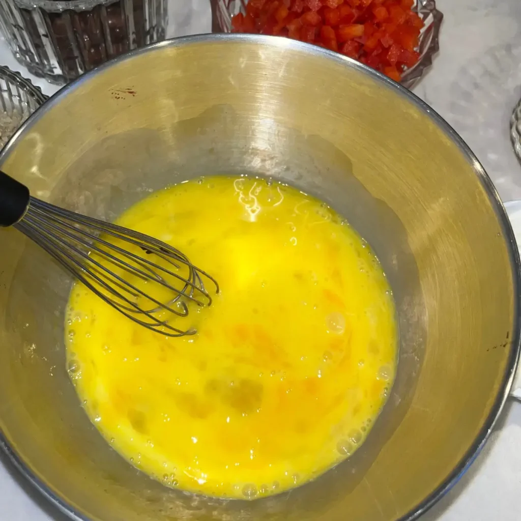 Eggs being whisked in a bowl for the quinoa breakfast bake.