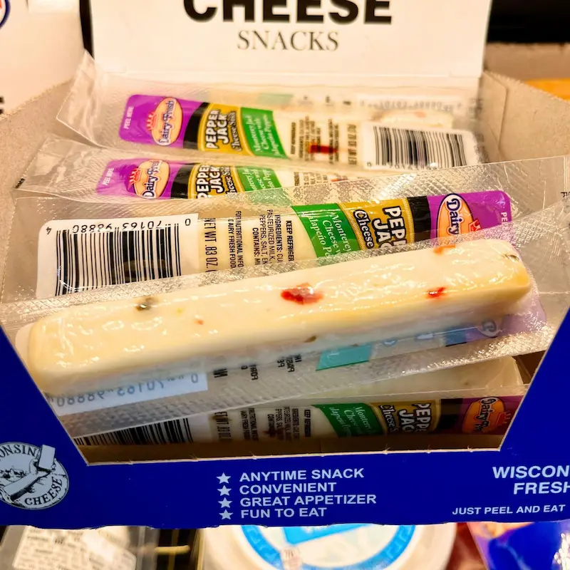 Cheese sticks in a box at a gas station for healthiest gas station snacks.