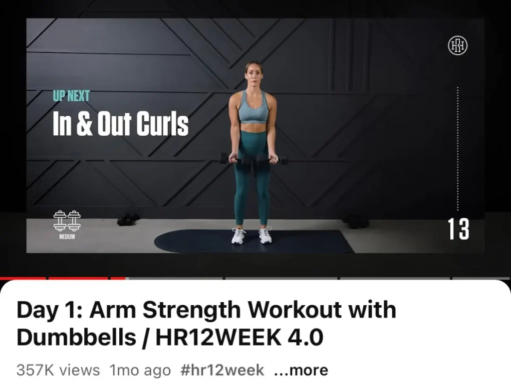 Heather Robertson performing in and out bicep curls on her YouTube channel.