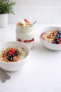 Strawberry overnight oats, a bowl of oatmeal and a chia bowl on a bright white counter in a kitchen.