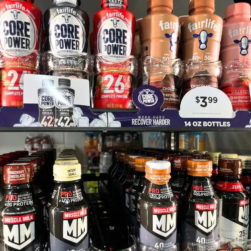 Milk and protein shakes in a fridge at the gas station for healthiest gas station snacks.