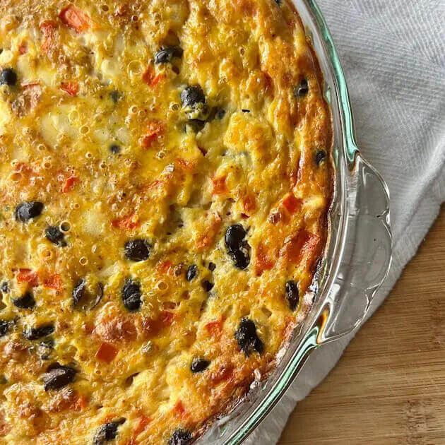 A close-up of a quinoa breakfast bake on a cutting board main header image.