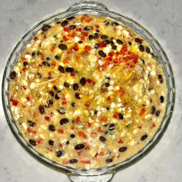 The quinoa breakfast bake mixture poured into a baking dish prior to cooking.