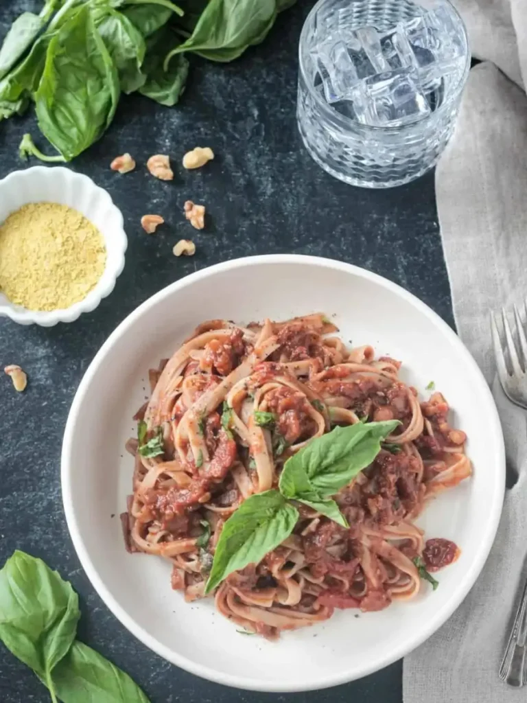 Lentil Bolognese pasta on a plate on a dinner table for a plant-based meal prep idea that's high in protein.