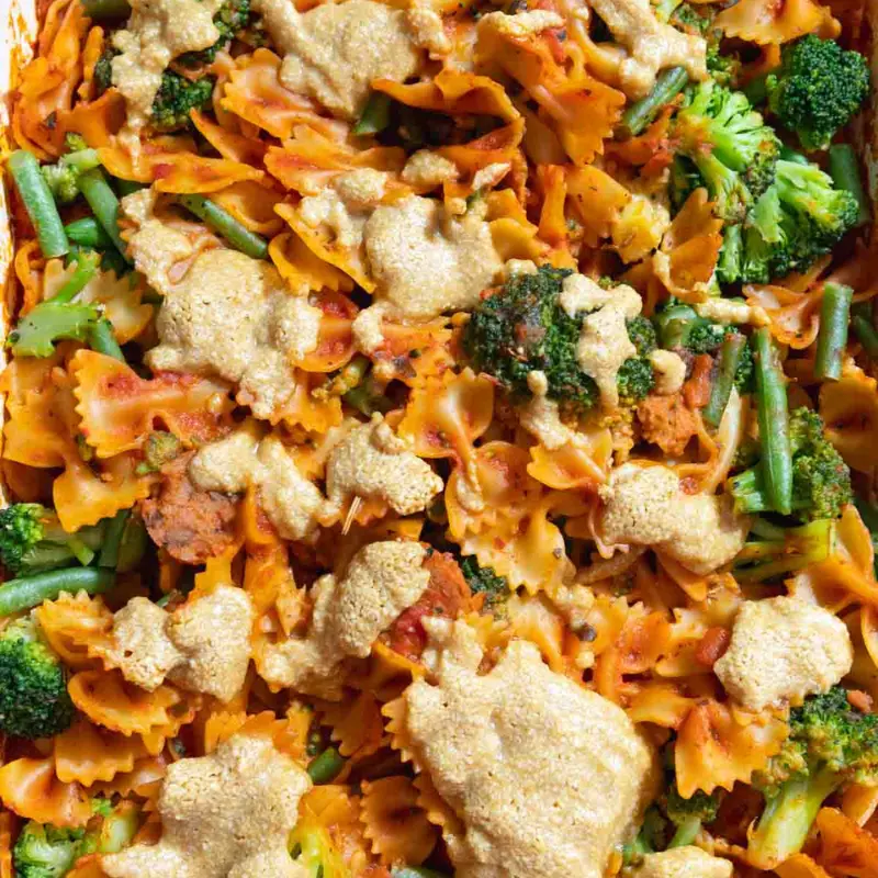 A no boil pasta bake with noodles, broccoli and sauce in a pan.
