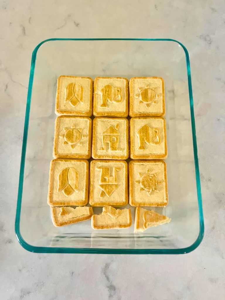 Assembling entire chessmen cookies into the bottom of a rectangle Pyrex container. 