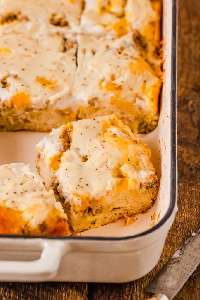 Biscuits and gravy casserole in a large white baking pan.