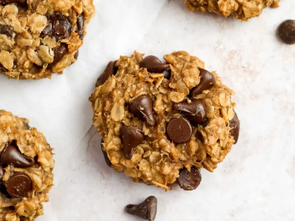 Chocolate and banana oatmeal cookies on a sheet of parchment paper.