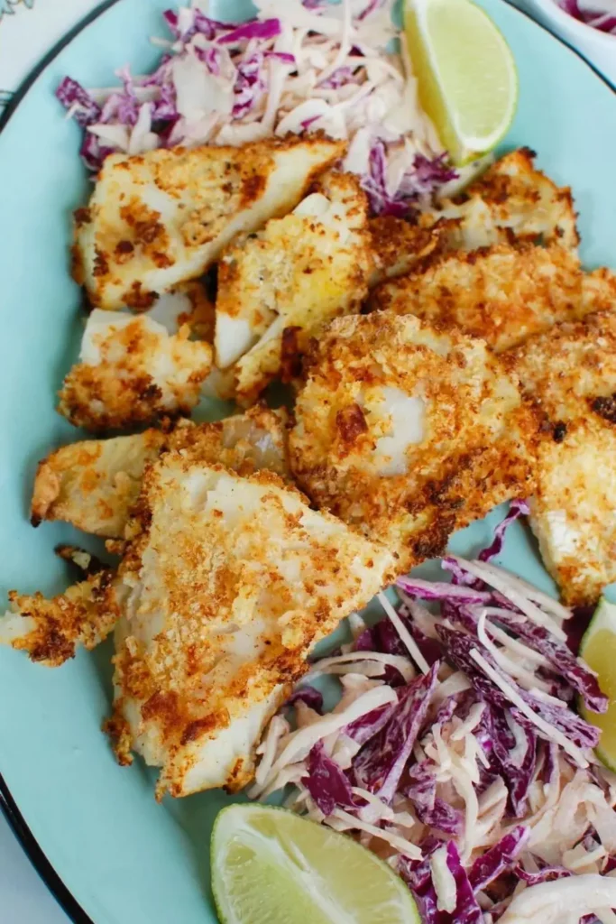 Bite-sized pieces of air fryer cod on a plate next to diced radishes.