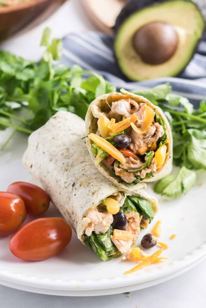 Two BBQ chicken salad wraps on a plate.