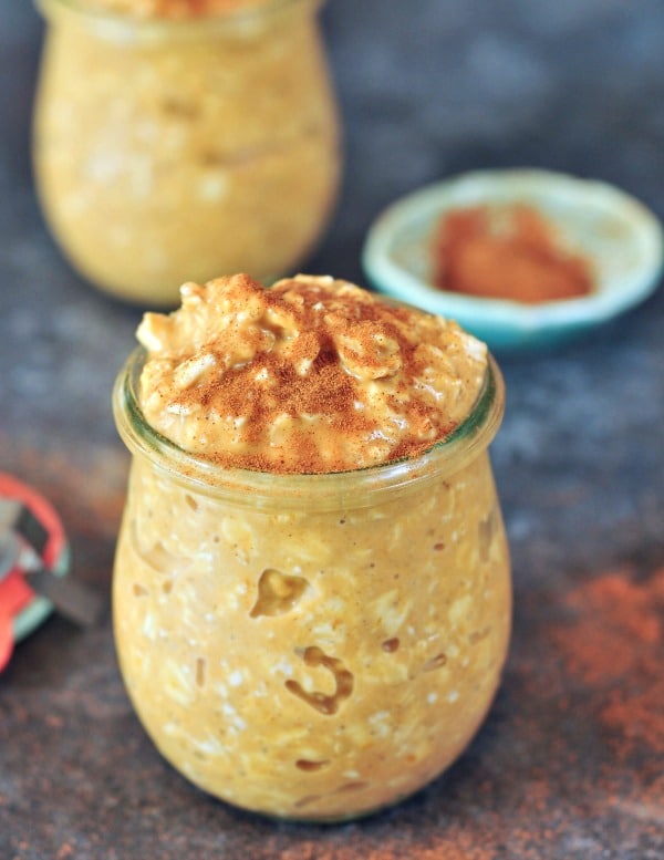 Easy pumpkin overnight oats in a glass jar on a table.