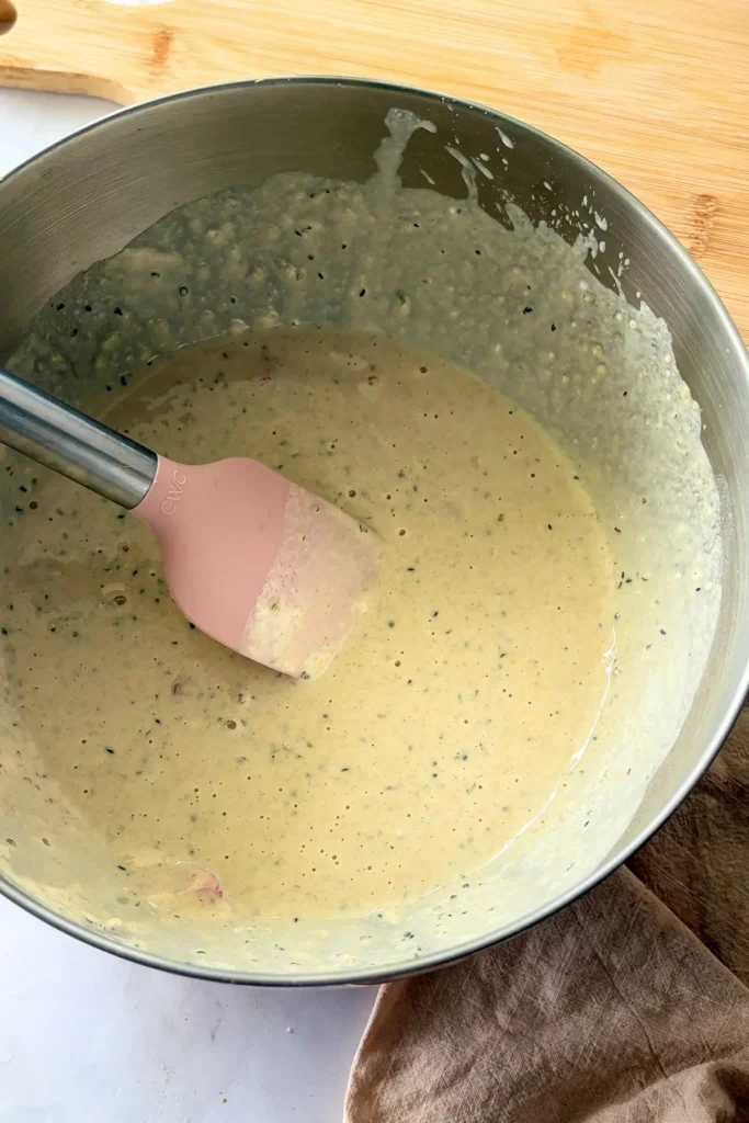 The donut batter mixed in a bowl on a counter.