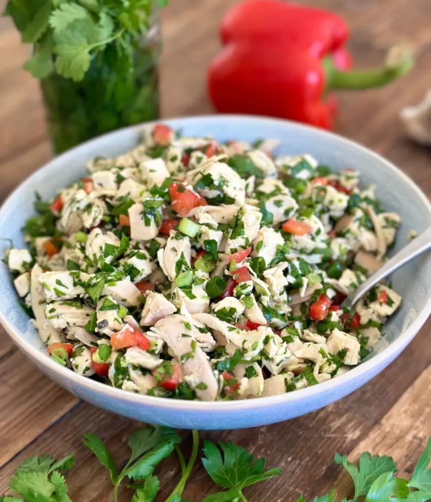 A dairy-free, gluten-free chimichurri salad in a bowl on a table.