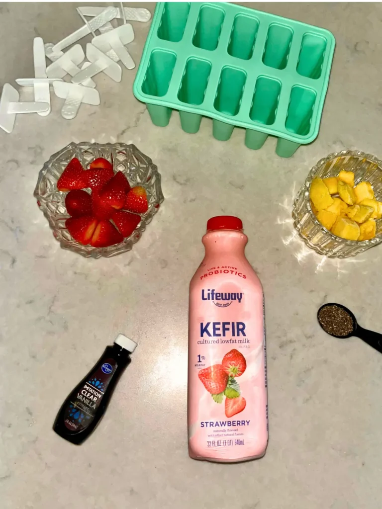 Ingredients for the strawberry mango immune boosting popsicles on a counter.