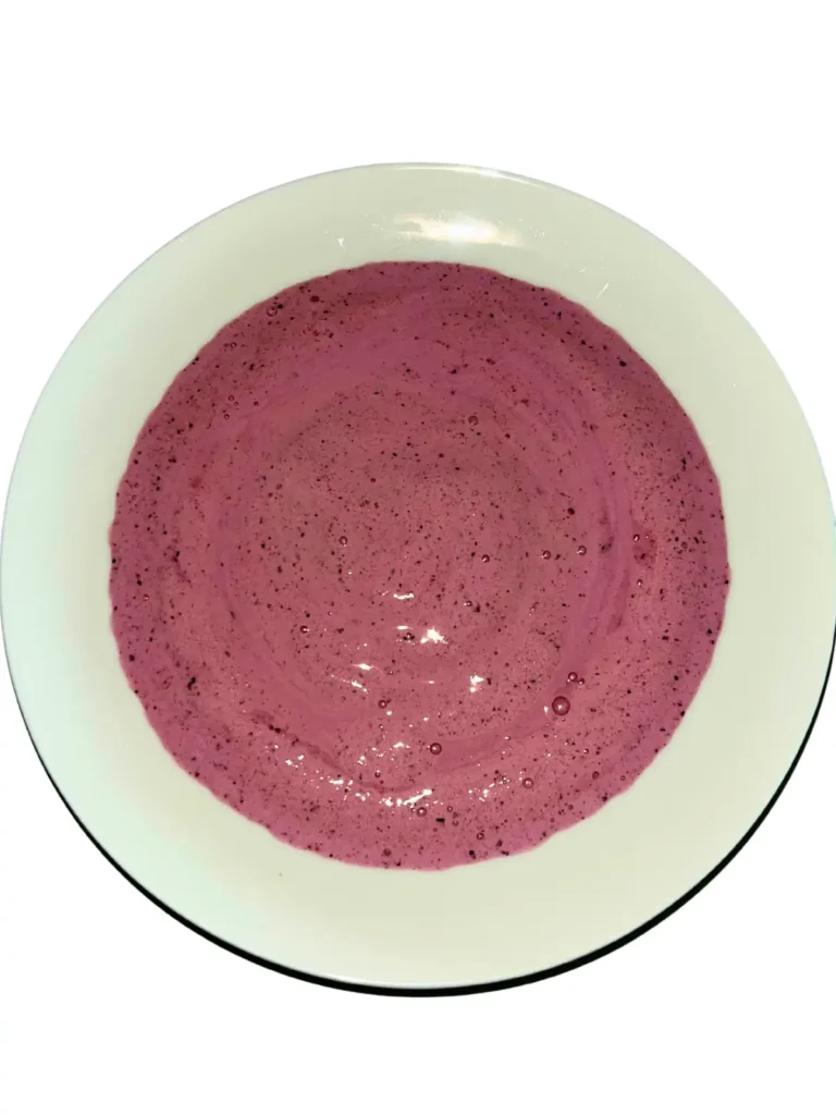 The smoothie bowl puree in a white bowl.
