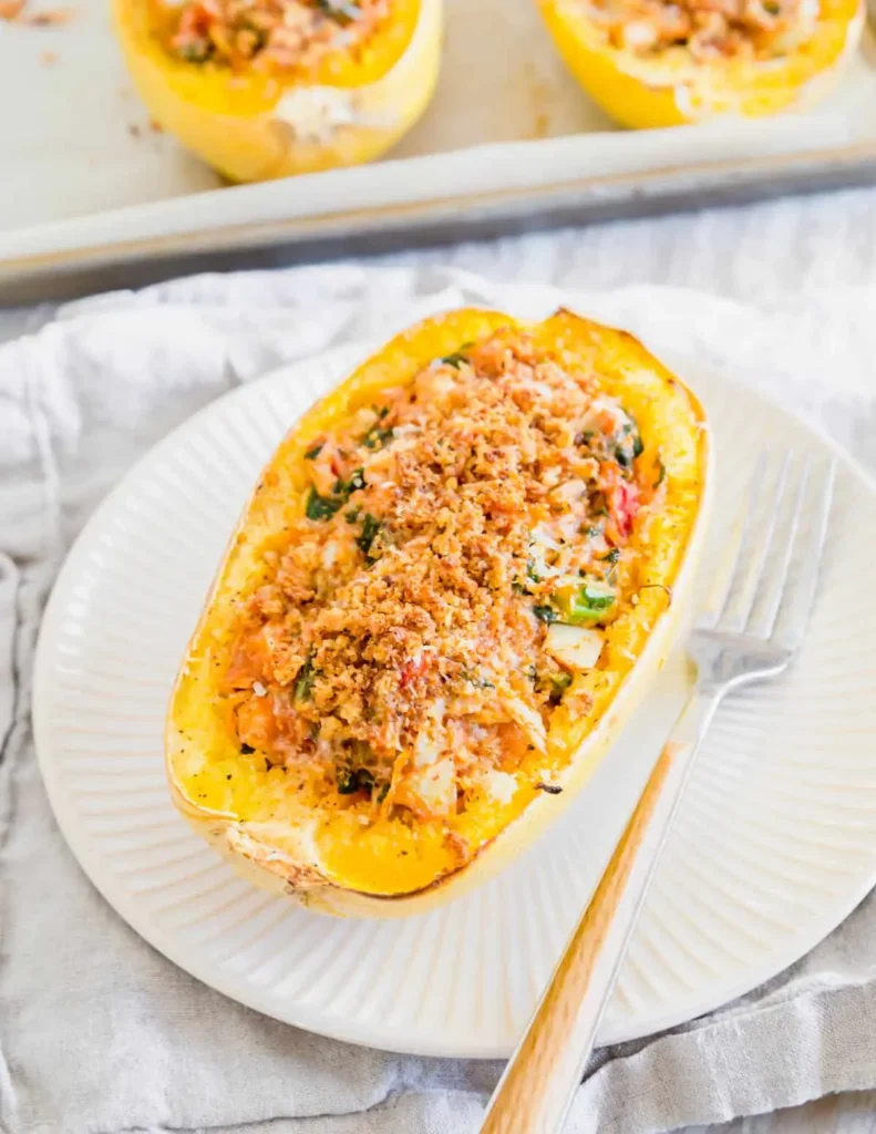 A twice baked spaghetti squash with a fork on a plate.