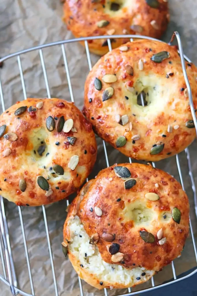 Cottage cheese protein bagels on a cooling rack on the counter.