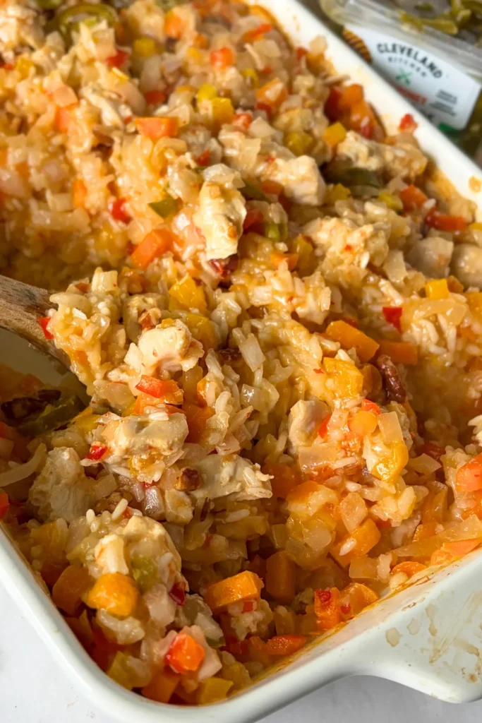 A birds-eye view of the creamy coconut chicken in a white casserole dish on a counter.