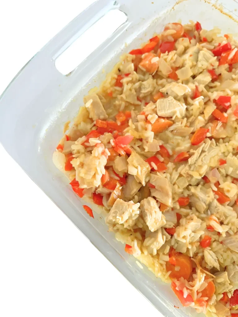 Creamy coconut chicken and rice casserole close-up in a 9 x 13 baking dish.