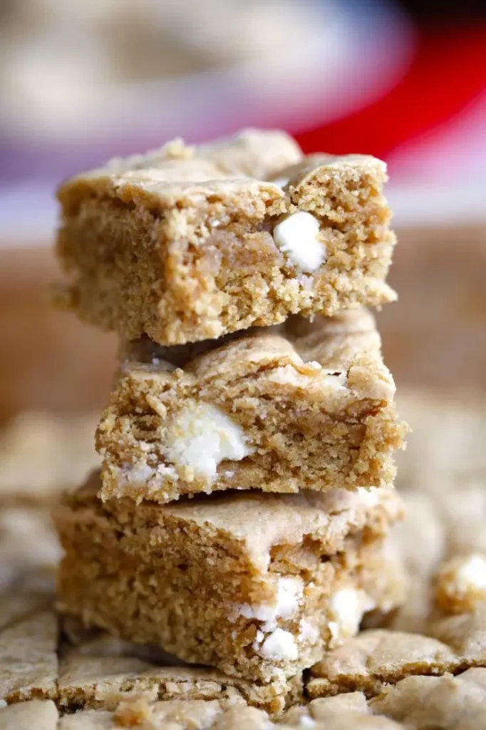 Peppermint white chocolate brownies made with chickpeas stacked on top of one another on a plate.