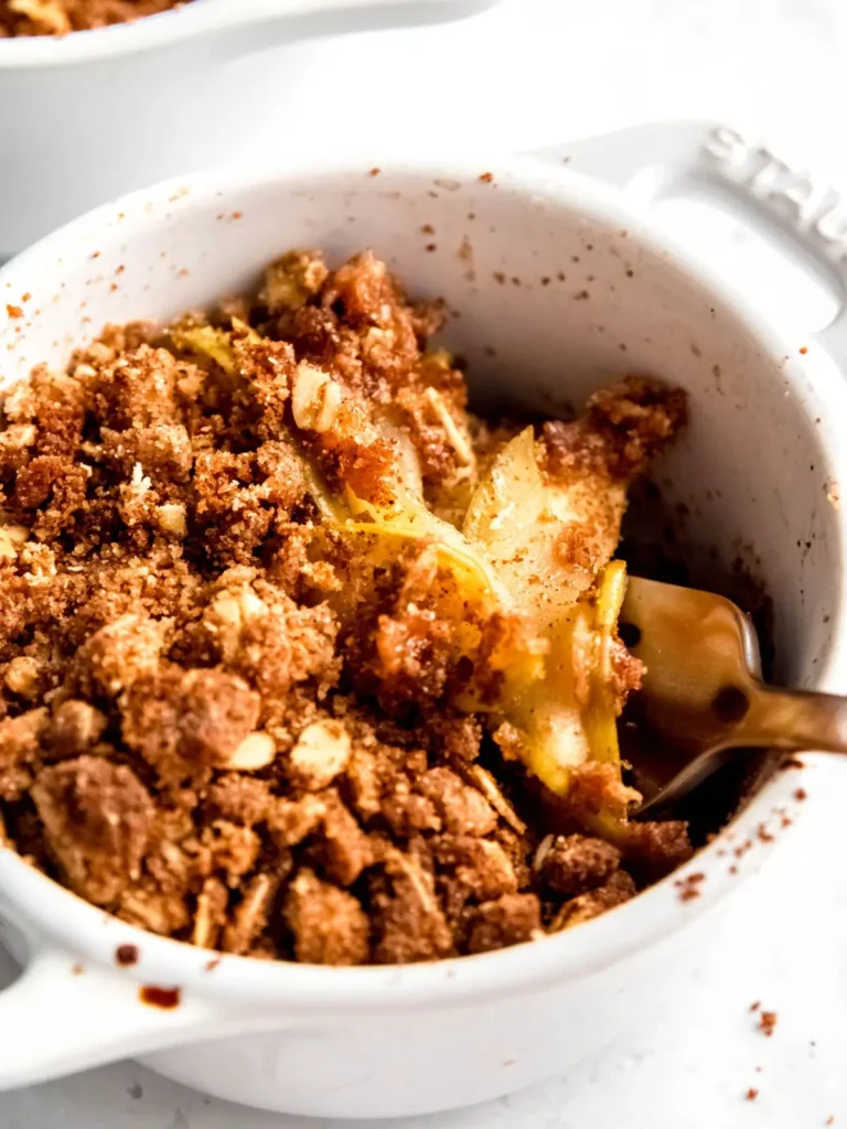 Air fryer apple crisp with a crumble topping in a baking dish.