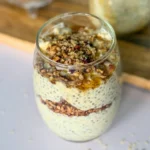 A birds-eye view of maple and brown sugar overnight oats with pecans on a counter.