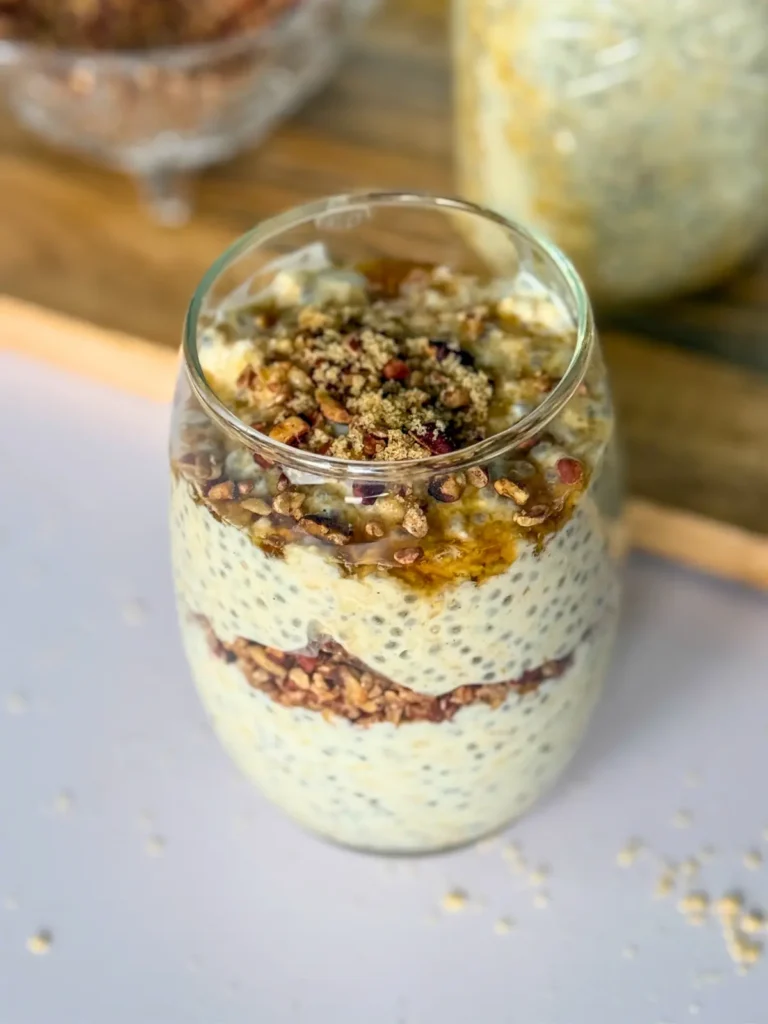 A birds-eye view of maple and brown sugar overnight oats with pecans on a counter.