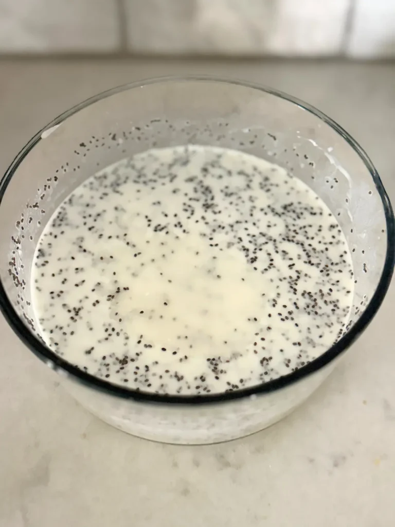 The overnight oats mixture before refrigeration in a large glass bowl.