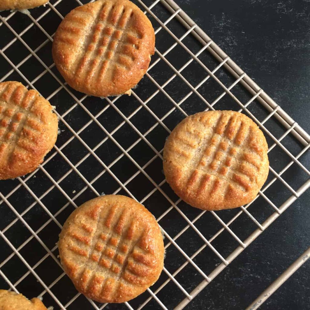 Air fryer peanut butter cookies on a cooling rack after baking.