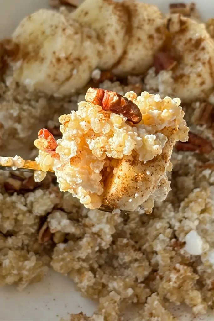 A spoonful of coconut quinoa with bananas and pecans.