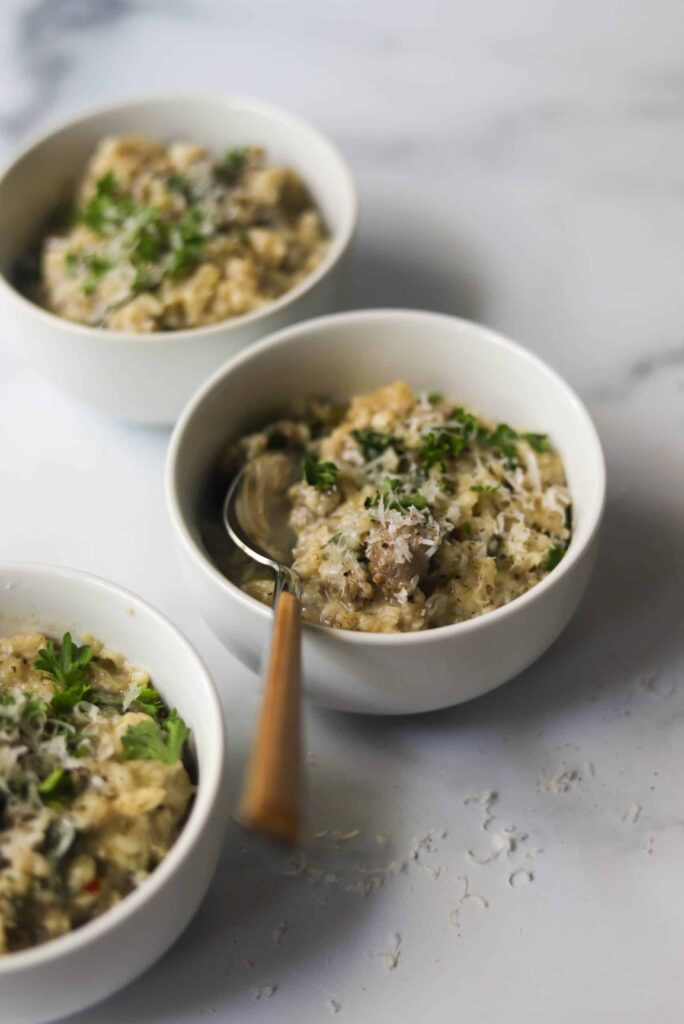 Three bowls of slow cooker Italian risotto on a table.