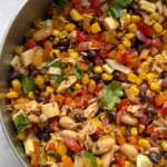 A left sided image of a bowl of dense bean salad .