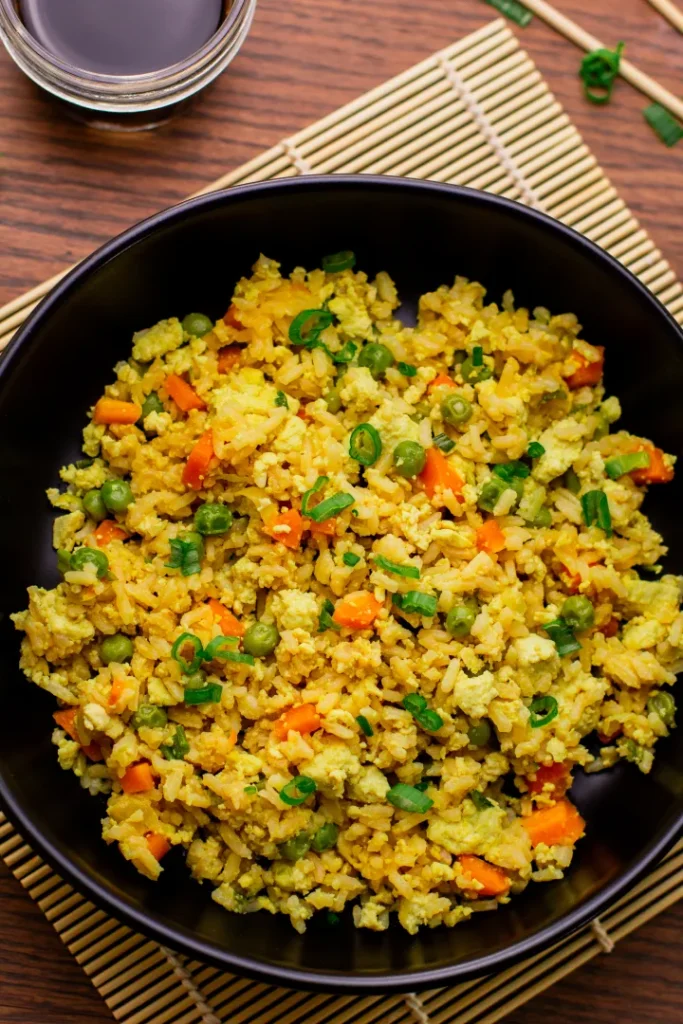 A pan of vegetarian tofu fried rice on a table.