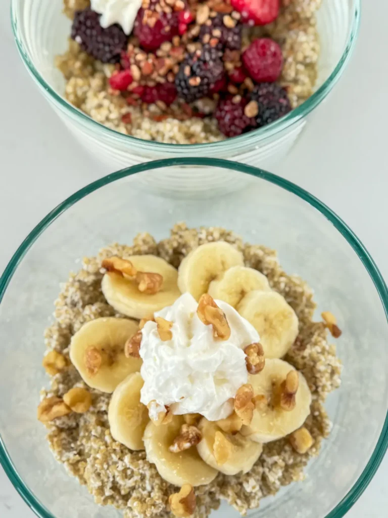 Two variations of a high protein quinoa breakfast bowl with coconut milk: one topped with bananas and chopped walnuts and the other with mixed berries and pecans.