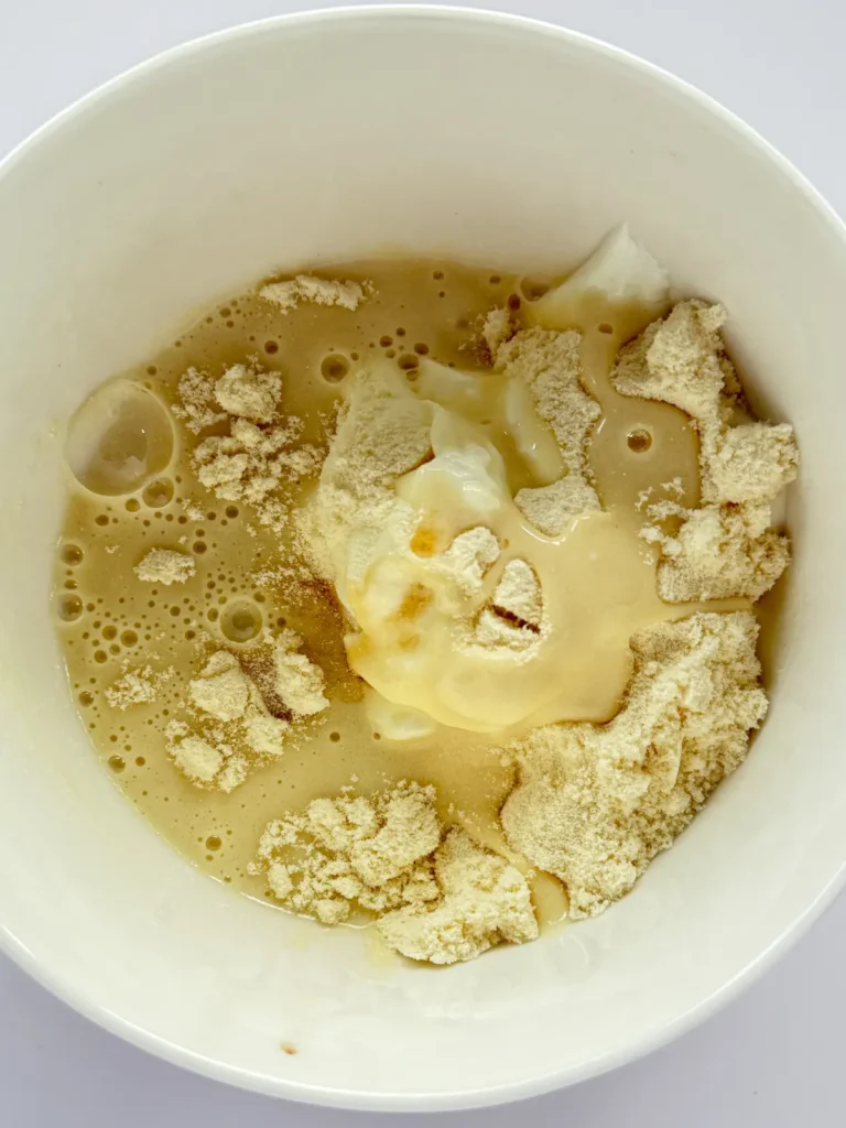 The ingredients for the cinnamon roll pudding in a bowl.